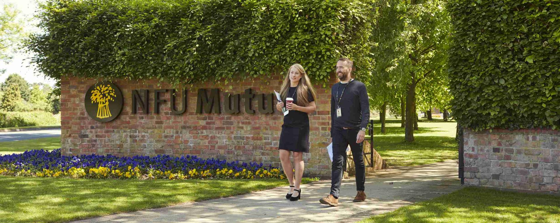 NFU Mutual Company Front with 2 Employees Walking