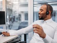 Person conducting a coaching conversation over the phone.